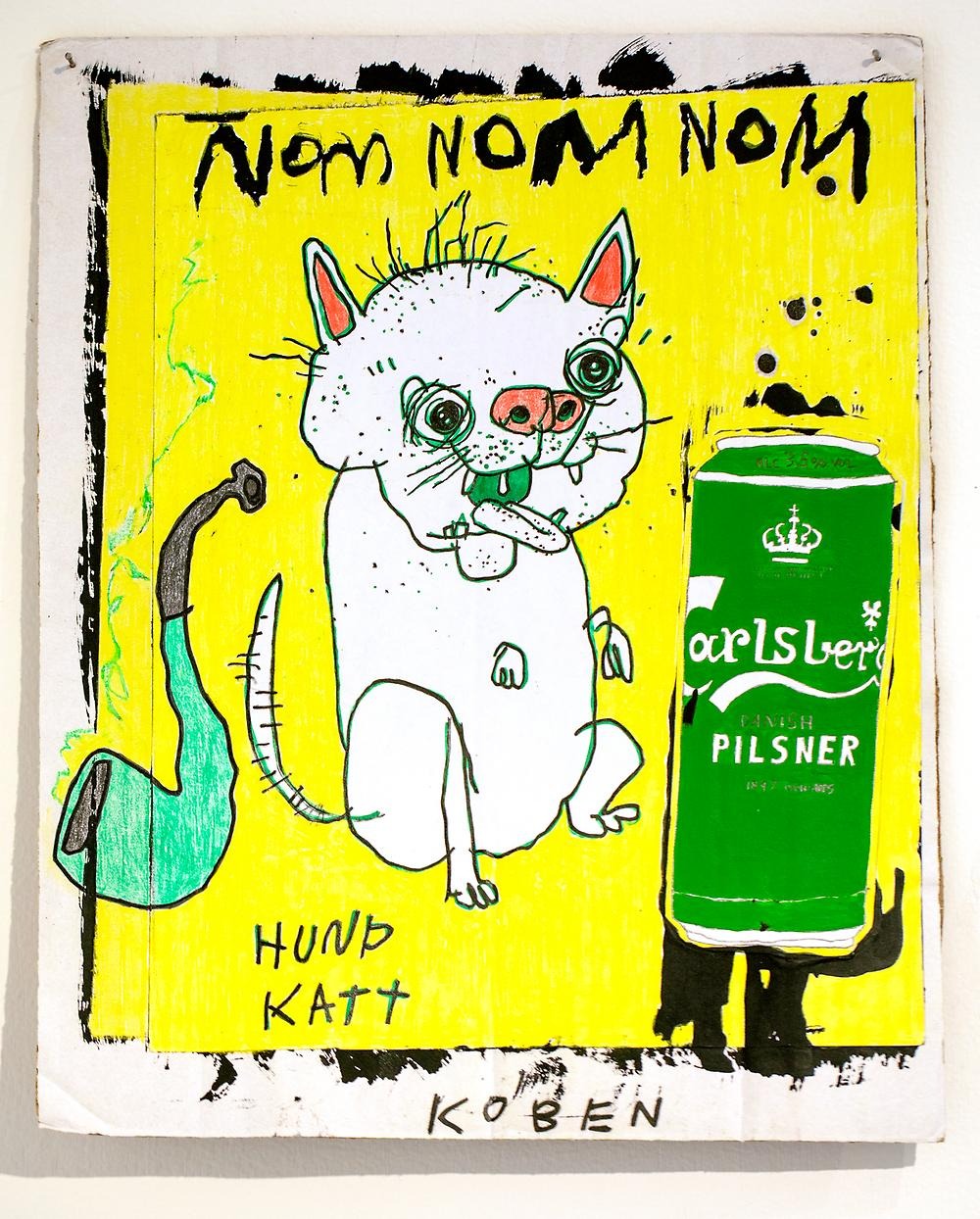 A drawing with a yellow background, a cat/dog, a beer can and a pipe. At the top of the picture it says NOM NOM NOM, at the bottom of the picture it says DOG CAT & KOBEN. It is drawn in a childish style.