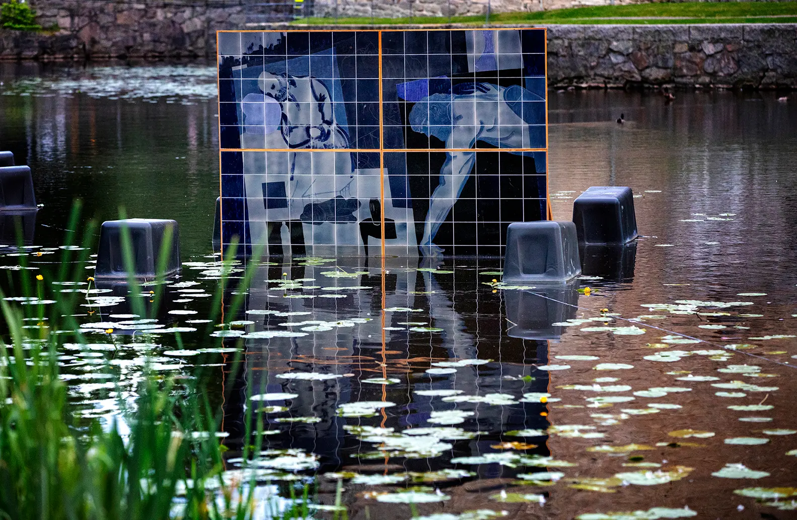 Close-up of one of the paintings made of ceramic tiles in shades of blue that are placed in the water around Örebro Castle.